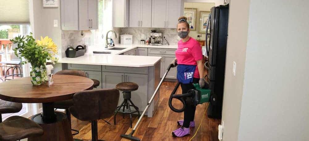 employee vacuuming the kitchen